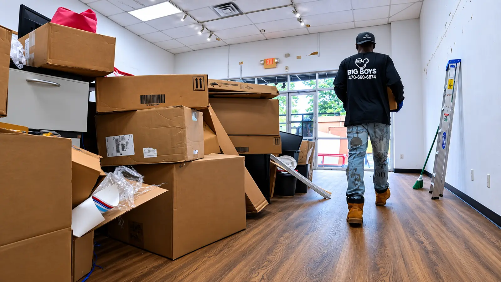Big Boys crew member clearing boxes from a commercial property